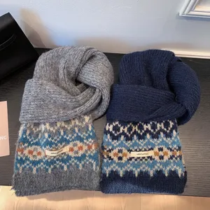 Close-up detail of soft knitted Fair Isle pattern scarves in grey and navy blue, warm and cozy.