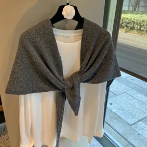 Grey knitted triangular scarf and white long-sleeve top set, stylish layered knitwear variant.