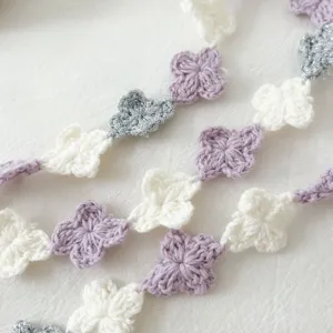 Detailed close-up of colorful crochet flower lace trim, perfect for DIY garment accessories.