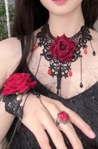 Close-up detail shot of gothic black lace rose choker necklace and bracelet ring jewelry set.