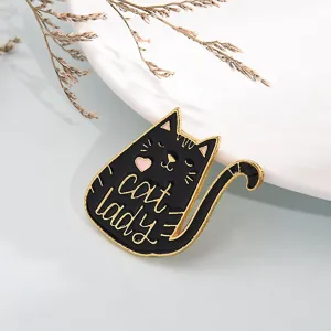 Close-up detail of the cute black cat enamel brooch with golden outline and lovely design.