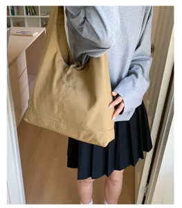 Casual khaki canvas hobo shoulder tote bag detail shot, vintage large capacity everyday use.