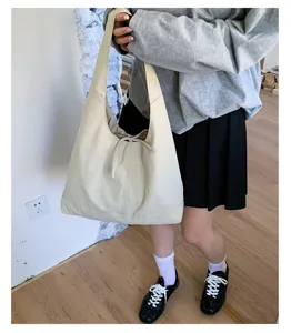 Beige slouchy canvas shoulder tote bag detail, perfect for daily commuting and casual styling.