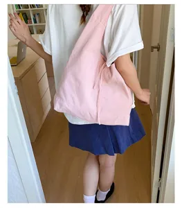 Large capacity pink canvas shoulder bag for women, casual retro tote bag daily commuting lifestyle view.