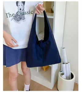 Large capacity dark blue canvas shoulder bag casual commuter tote bag for women daily use.