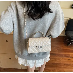 Elegant quilted leather small square shoulder bag with chain strap and chic metal turn-lock.