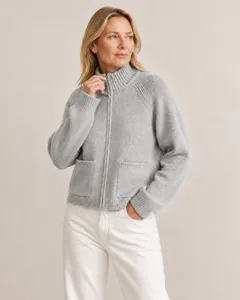 Detailed close-up showing the collar, front zipper, and pockets of the grey knit cardigan.