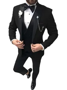 Close-up detail of black slim fit three-piece suit, vest, bow tie, and pocket chain.