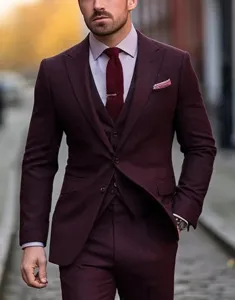 Burgundy men's 3-piece suit detail featuring tailored jacket, vest, trousers and tie.