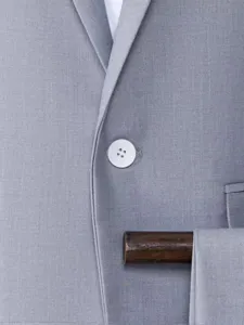 Men grey suit jacket detail close up, premium fabric texture and single button design.
