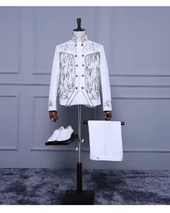 Detailed view of men's vintage stage performance suit, white jacket with silver fringe embroidery.