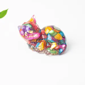 Close-up detail of a colorful crystal stone resin cat figurine, perfect desktop decor ornament.