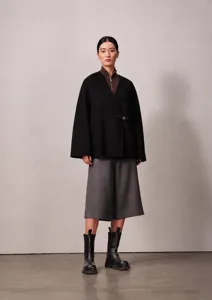 Detail view of women short wrap cashmere coat with V-neck design, elegant autumn winter apparel.