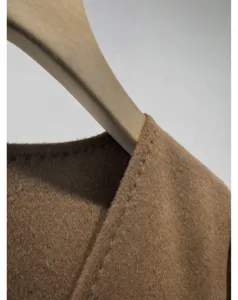Detailed shot of a brown wool cashmere wrap V-neck short coat women fashion apparel.