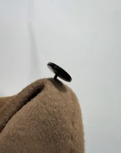 Detailed view of the premium cashmere wool coat, highlighting fine button craftsmanship.