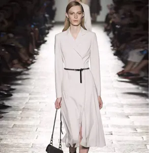 Elegant runway model showcasing a minimalist thin black leather belt and stylish outfit detail.