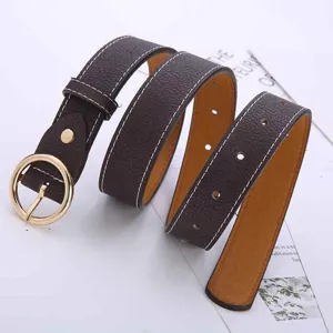 Detailed close-up view of stylish brown women leather belt with round gold metal buckle.