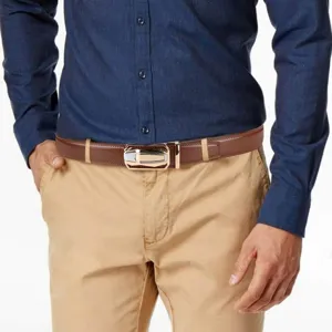 Men's brown leather belt paired with casual pants, showing the metallic automatic buckle.