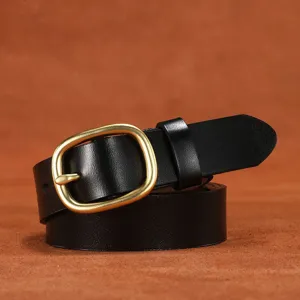 Close-up detail of women's black leather belt with vintage brass metal pin buckle accessory.