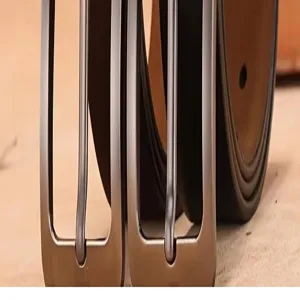 Close-up detail view of classic men's metal belt buckles showcasing smooth finish.