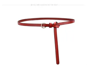 Red leather thin belt detail showing the stylish metal O-ring buckle and elegant knot design.