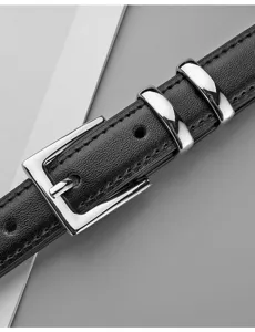 Détail en gros plan d'une ceinture pour femme en cuir véritable noir avec boucle ardillon.