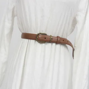 Elegant brown leather belt for women with ornate vintage metal buckle, perfect waist accessory.