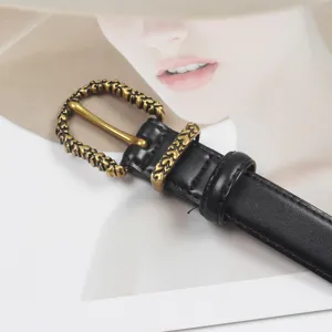 Close-up of women's black leather belt featuring an intricate vintage bronze buckle and loop.