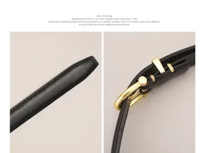 Detailed close-up view of womens minimalist leather belt featuring a sleek metal pin buckle.