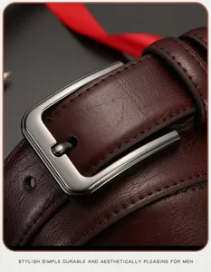 Close-up detail of men's brown leather belt with metal pin buckle and textured finish.