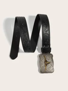 Close-up detail of vintage western style engraved leather belt buckle and embossed strap.