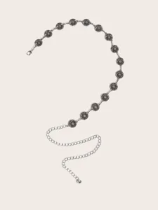 Detailansicht einer silberfarbenen Metall-Taillenkette mit zarten Sonnenblumen-Anhaengern.
