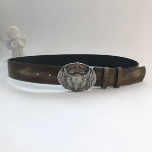 Western vintage distressed leather belt for women with unique metal bull skull buckle detail.