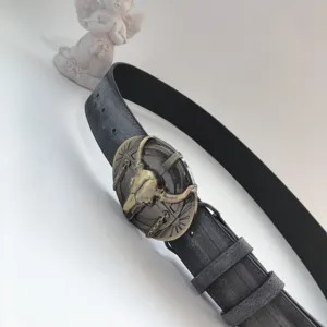 Vintage bull skull metal buckle black leather belt detail, chic hip hop western style accessory.
