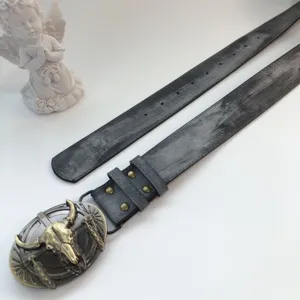 Vintage retro style cow skull buckle leather belt detail view with punk fashion design