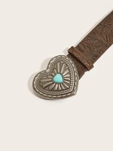 Close-up of a retro brown leather belt with ornate silver heart buckle and turquoise stone.