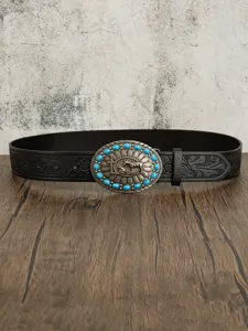 Detailed view of western leather belt with turquoise stone oval buckle and embossed floral pattern.