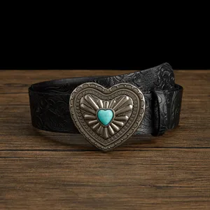 Vintage western cowgirl leather belt with embossed floral pattern and turquoise heart buckle.