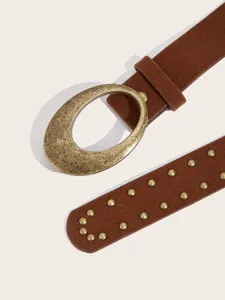 Detailed view of vintage brown suede belt with distressed brass oval buckle and metal studs.