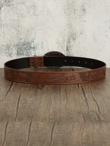 Detailed view of brown leather belt with vintage floral embossed patterns and metal buckle.