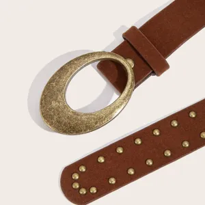 Vintage brown suede belt featuring an antique brass oval buckle and stylish metal stud details.