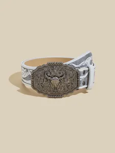Closeup of Western cowboy style white leather belt with antique metal bull skull buckle design.
