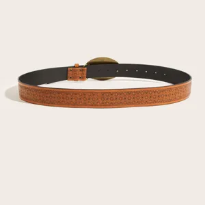 Detailed shot of vintage printed leather belt with carved buckle showing fine tooling texture.