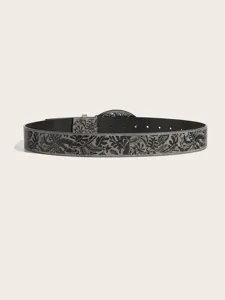 Detail view of a stylish textured leather belt featuring an intricate tropical leaf pattern print.