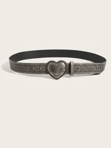 Detailed view of vintage silver heart buckle belt with intricate engraved geometric patterns.