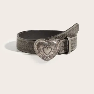 Detailed view of a vintage embossed pattern leather belt featuring a large silver heart buckle.