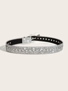 Detailed view of women sparkling rhinestone belt with metal grommets and glossy finish.