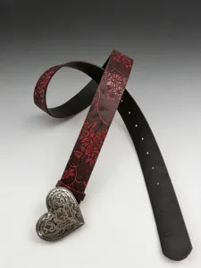 Detailed view of women's western retro heart embossed leather belt with ornate silver buckle.
