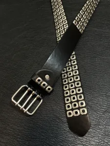 Black punk rock style leather belt featuring metal grommets unisex styling accessory