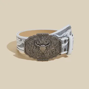Western cowboy style leather belt with vintage bull skull buckle, embossed floral details.
